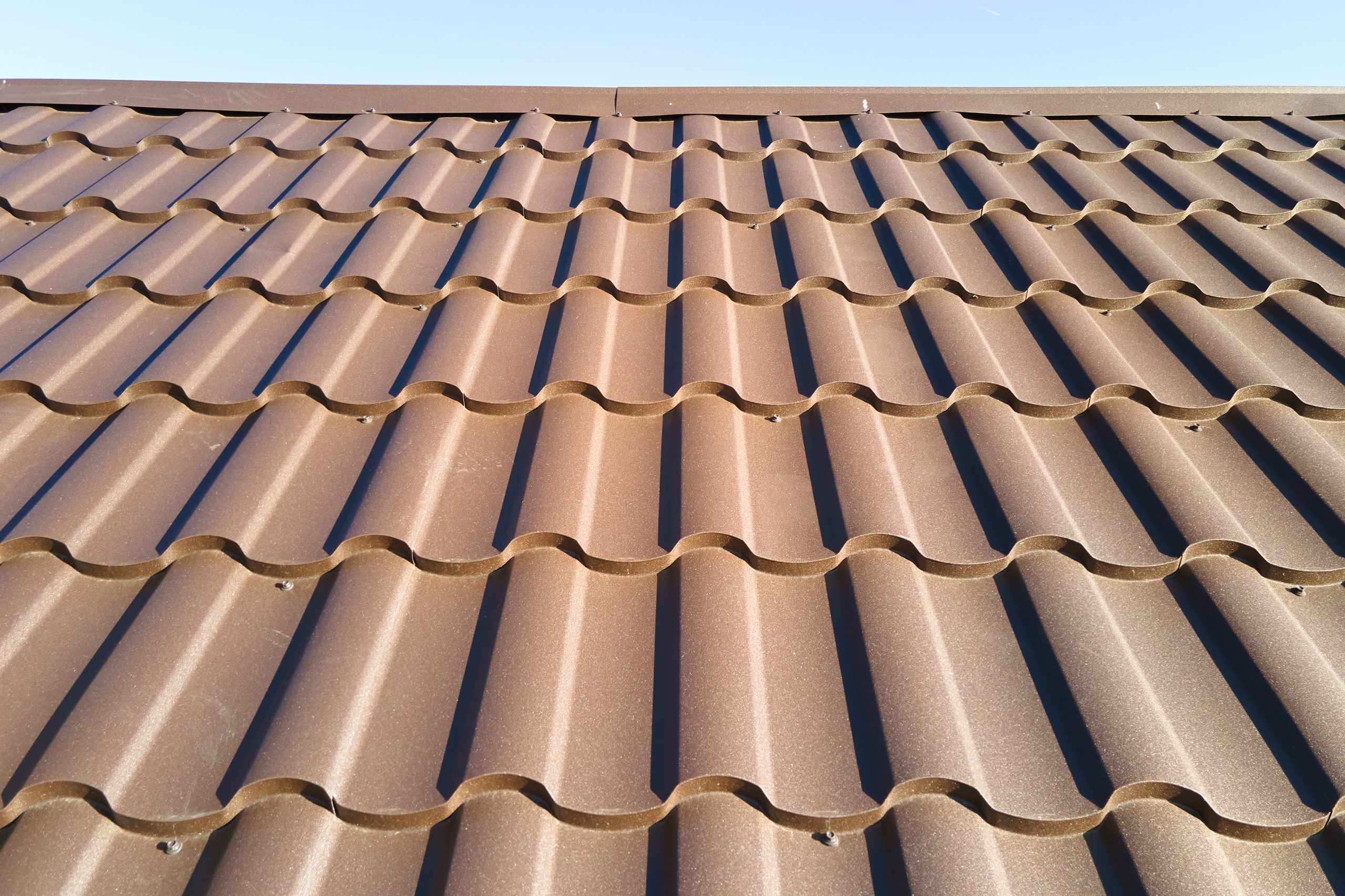 Closeup of house roof top covered with metallic shingles